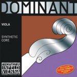 The image shows the packaging for Thomastik-Infeld Dominant viola strings with a synthetic core. The design features a decorative silver scroll and text on a silver and purple background.
