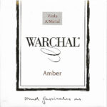 A white square package labeled "Warchal Amber" with "Viola A/Metal" in a box at the top, the Warchal logo in the center, and "sound fascinates us" handwritten at the bottom.
