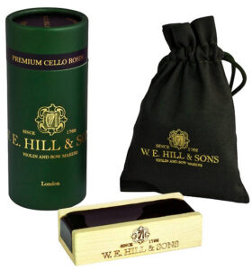 A set of Hill Deluxe Viola Rosin, featuring a green cylindrical container, a black drawstring pouch, and a wooden rosin block, all adorned with gold lettering and the Hill logo.