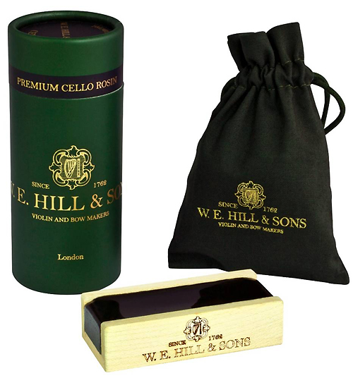 A set of Hill Deluxe Viola Rosin, featuring a green cylindrical container, a black drawstring pouch, and a wooden rosin block, all adorned with gold lettering and the Hill logo.